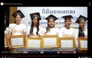 Four graduates smile proudly in their caps and gowns at a ceremony.